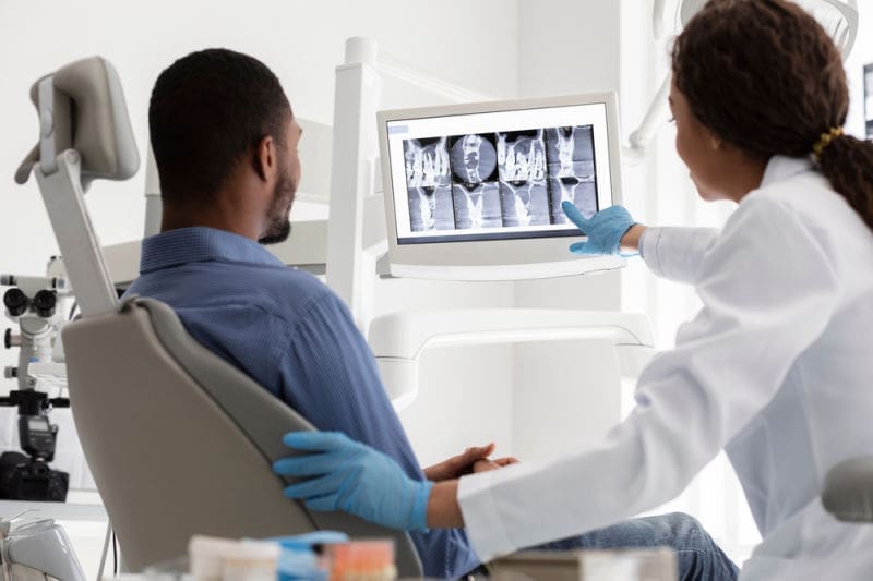 Best dentist in Boston MA | patient reviewing x-rays